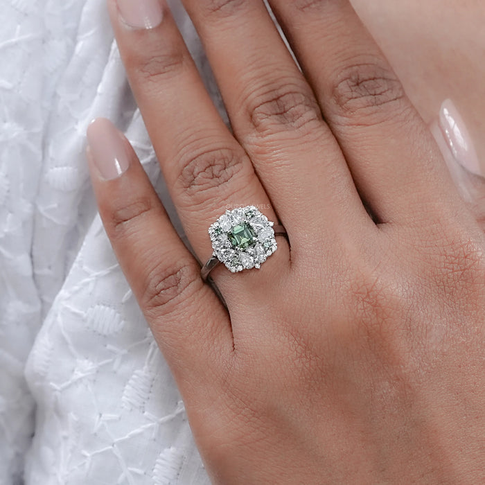 asscher cut green lab diamond cluster engagement ring in finger
