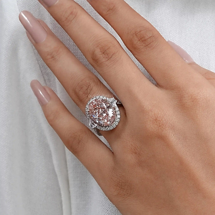 pink oval lab diamond with trapezoid halo wedding diamond ring in finger