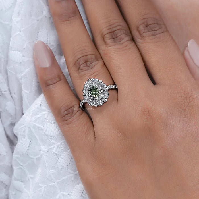 green pear cut surround double halo diamond engagement ring in finger
