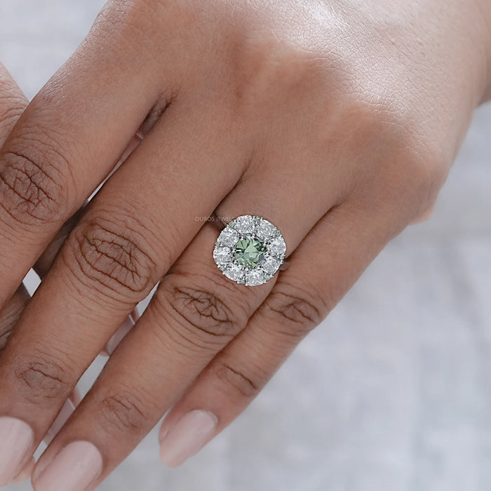green cushion cut lab diamond halo engagement ring in finger