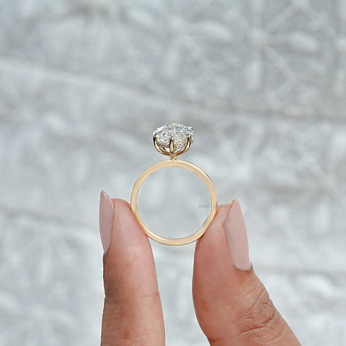 close up view of portuguese oval cut lab diamond 6 prong engagement ring