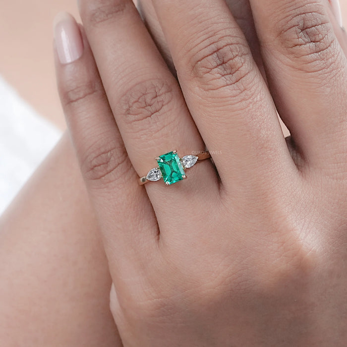 Emerald Gemstone And Pear Diamond Trio Engagement Ring