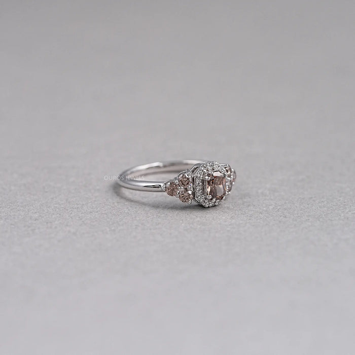 right side view of brown cushion cut diamond halo wedding ring on grey fabric