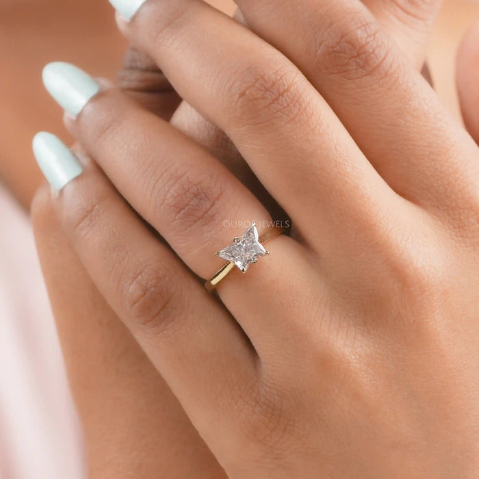 pink butterfly shape lab diamond solitaire proposal ring in finger