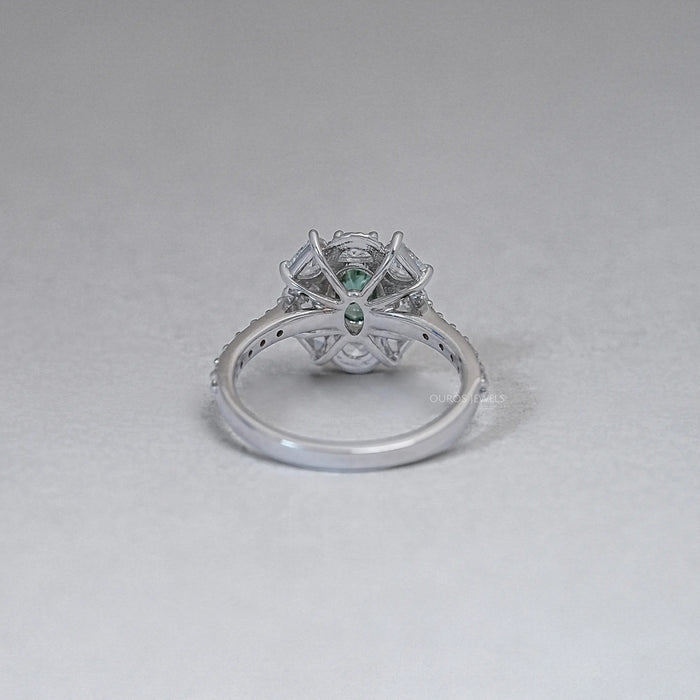 back view of green oval cut diamond half moon halo engagement ring