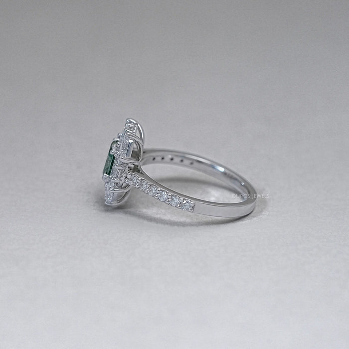 side view of green oval cut diamond half moon halo engagement ring