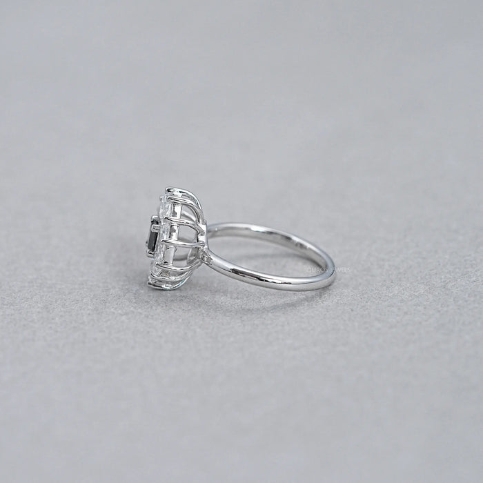 princess cut diamond dutch marquise halo engagement ring's side view on grey fabric