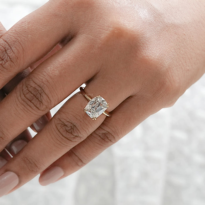 old mine cushion lab diamond solitaire engagement ring in finger