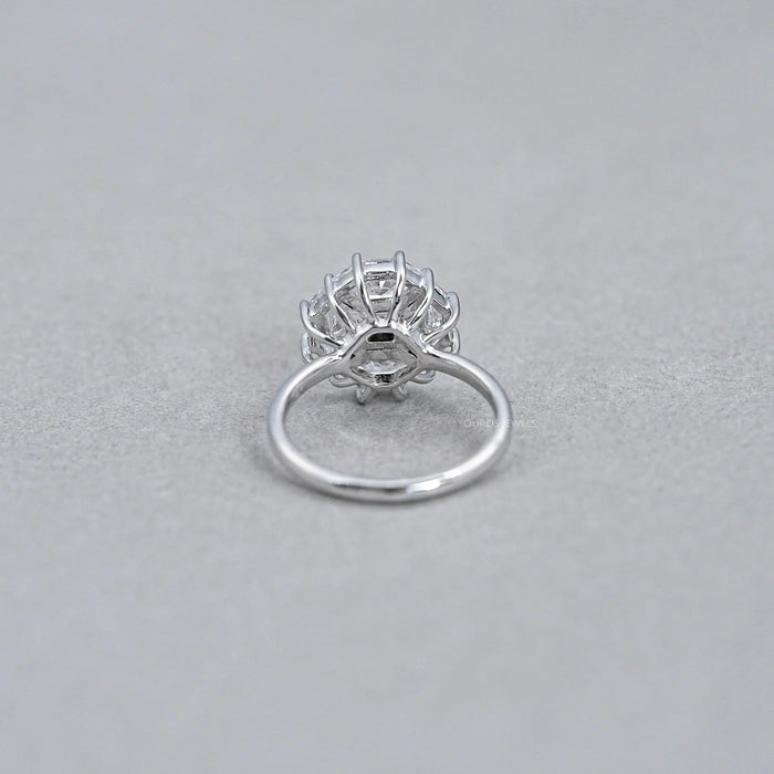 princess cut diamond dutch marquise halo engagement ring's back view on grey fabric