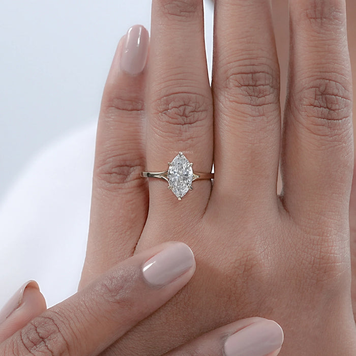 six prong marquise cut lab diamond solitaire engagement ring on model hand