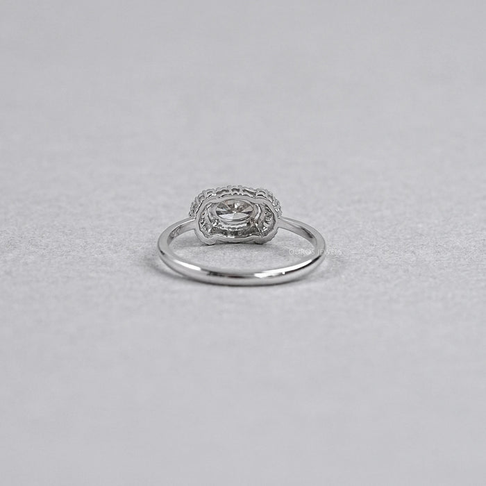 back view of olive oval diamond halo engagement ring on grey background