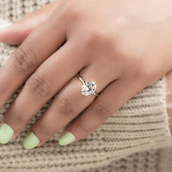 old mine oval cut lab diamond solitaire wedding ring on model's hand