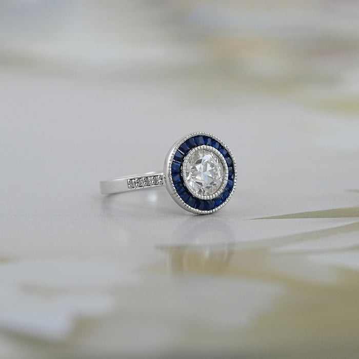 OEC Round Diamond Surround Sapphire Baguette Halo Ring