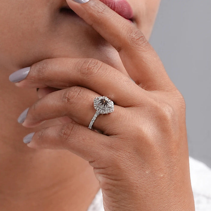 brown oval cut lab diamond double halo engagement ring on model's finger