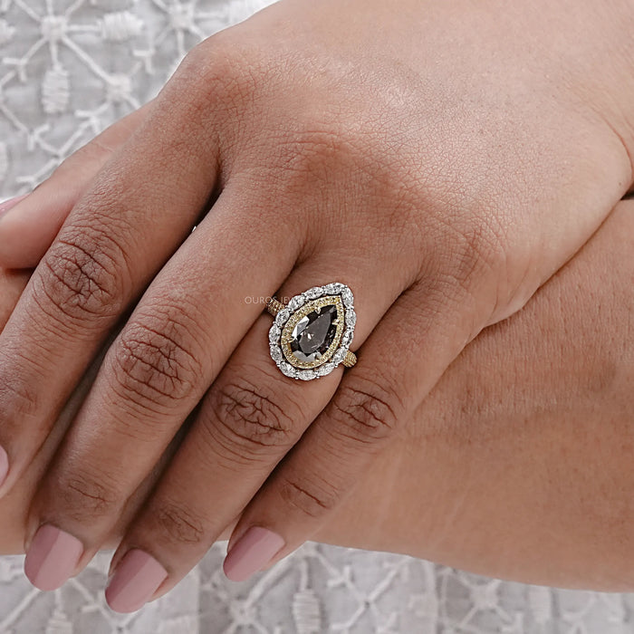 top view of brown pear diamond double hidden halo engagement ring in finger