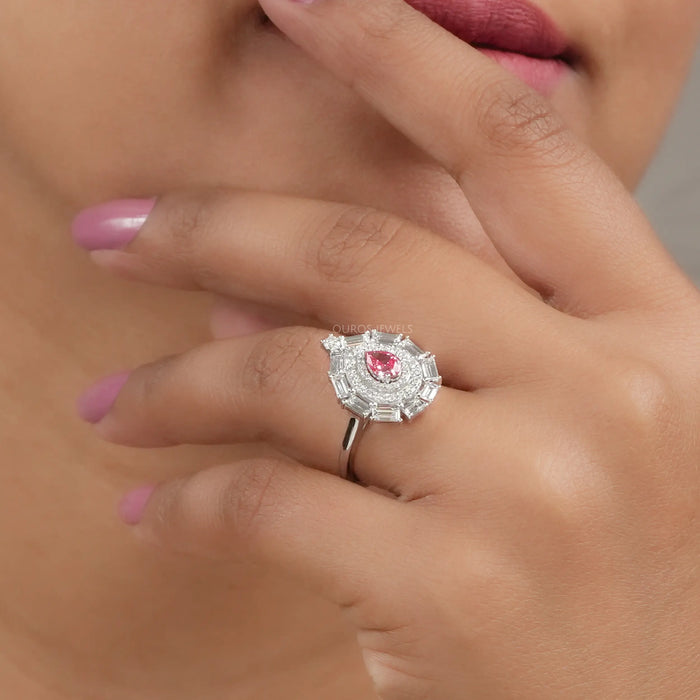 pink pear with baguette and round diamond double halo wedding ring on model's finger