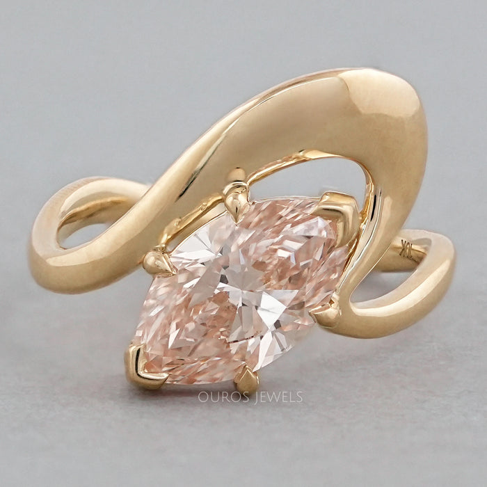 front view of pink marquise cut diamond bypass engagement ring in yellow gold