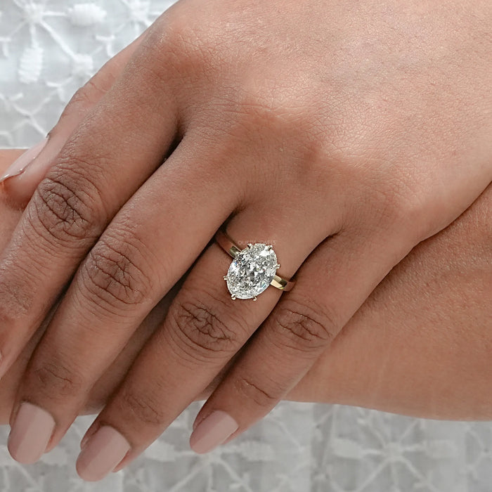 portuguese oval cut diamond 6 prong engagement ring on model's hand