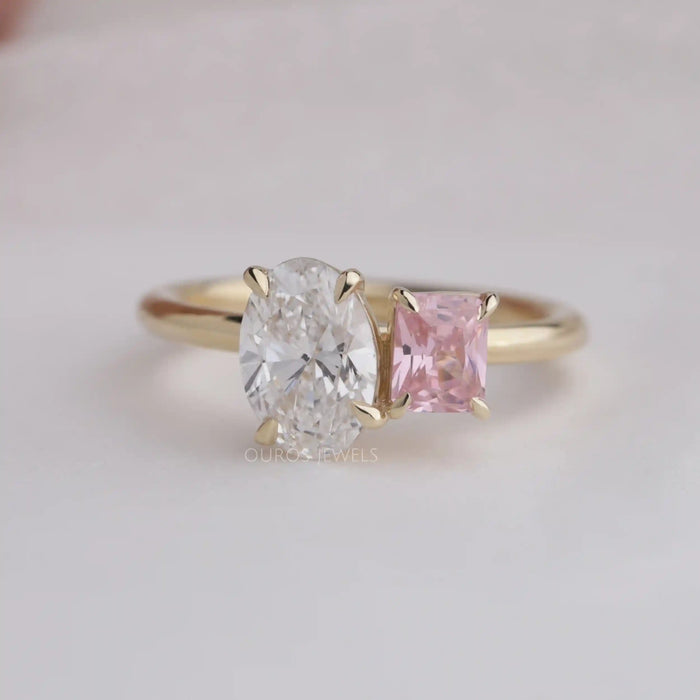 Wide oval engagement ring with pink radiant diamond