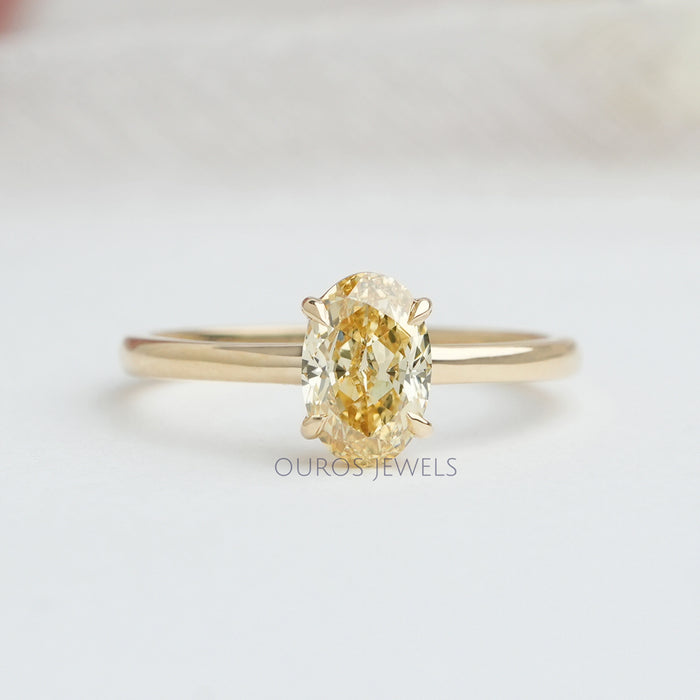 front view of yellow oval cut lab diamond engagement ring