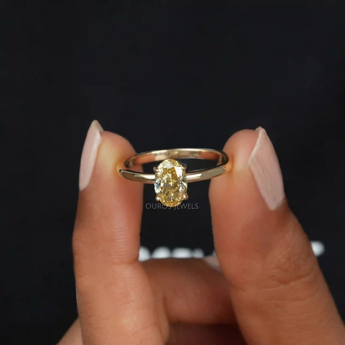 close view of yellow oval cut lab diamond engagement ring