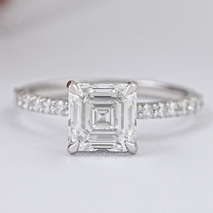 front view of asscher cut diamond solitaire accent engagement ring on grey fabric