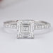 front view of asscher cut diamond solitaire accent engagement ring on grey fabric