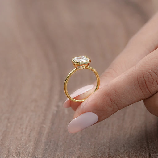 view of side angle asscher cut diamond bezel set solitaire engagement ring