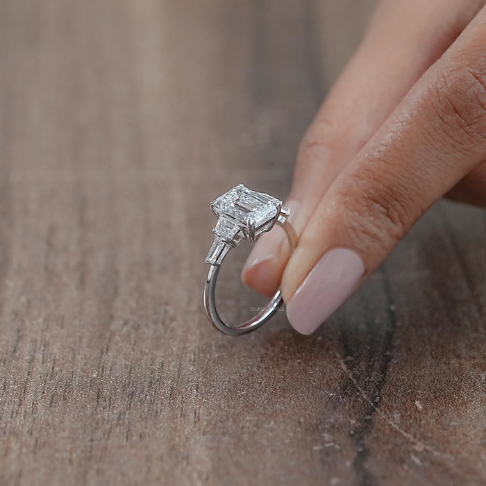 side view of emerald cut and trapezoid lab diamond five stone engagement ring