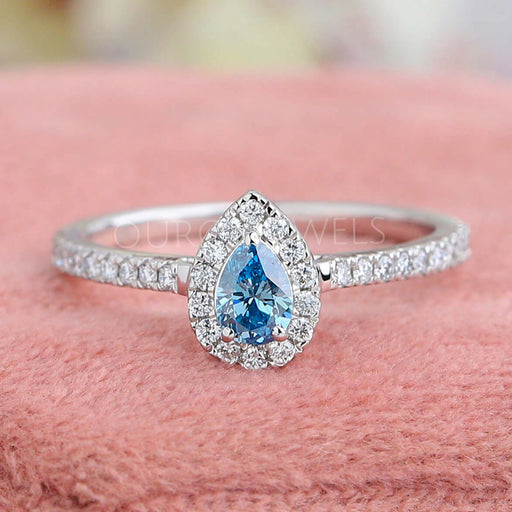 front view of blue pear-cut lab diamond halo colored engagement ring