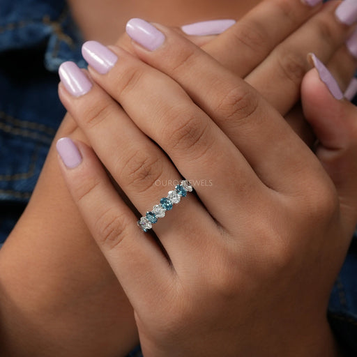 [A Women wearing Blue Oval Cut Eternity Wedding Band]-[Ouros Jewels]