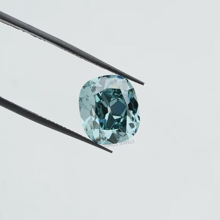 bluish cushion diamond holded with tweezer