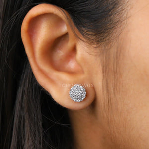 Cluster Round Cut Diamond Stud Earrings worn on a woman's ear, showcasing the intricate diamond clusters against her skin.