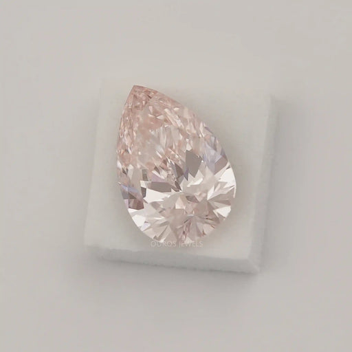 fancy intense pink pear shaped loose man made diamond on white surface