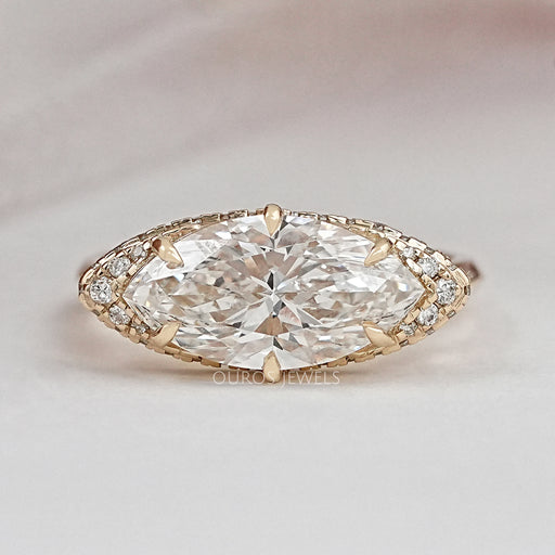 east west marquise diamond hidden halo engagement ring top view on grey background