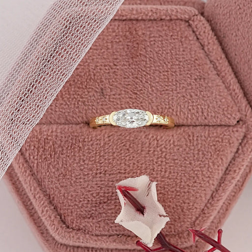 east-west old mine moval cut diamond half bezel engagement ring in jewelry box