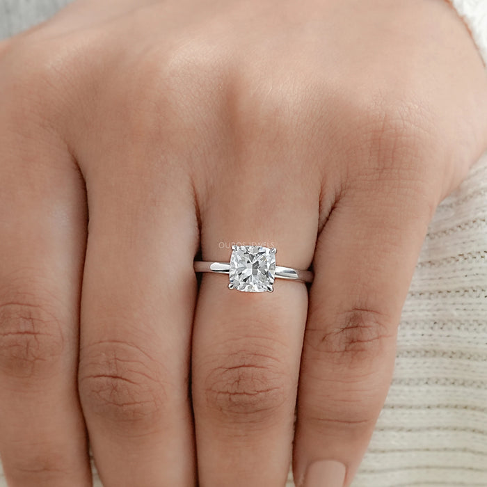 igi certified cushion cut diamond solitaire engagement ring in finger