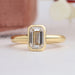 top view of emerald cut diamond bezel set solitaire engagement ring