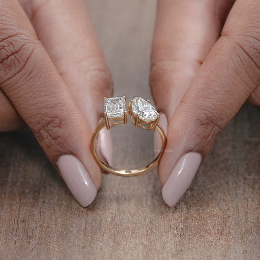 close view of emerald-cut and pear lab diamond toi et moi engagement ring
