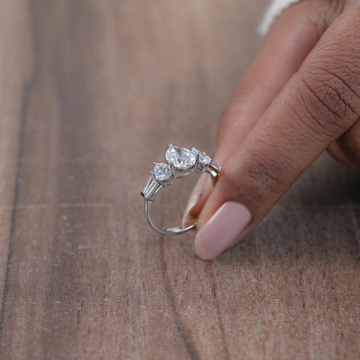 side view of pear cut lab diamond five stone engagement ring in white gold band