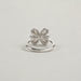 back view of olive pear cut diamond floral halo engagement ring on grey fabric