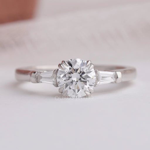 front view of round and tapered baguette diamond three stone engagement ring