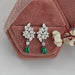 emerald gemstone and cluste diamond drop earrings