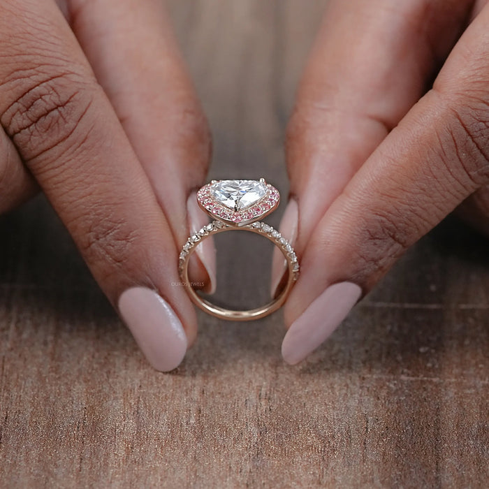 close view of heart-shaped diamond pink halo engagement ring