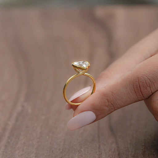 side view of heart-shape diamond bezel set solitaire engagement ring