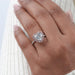 heart-shaped diamond pink halo engagement ring in finger