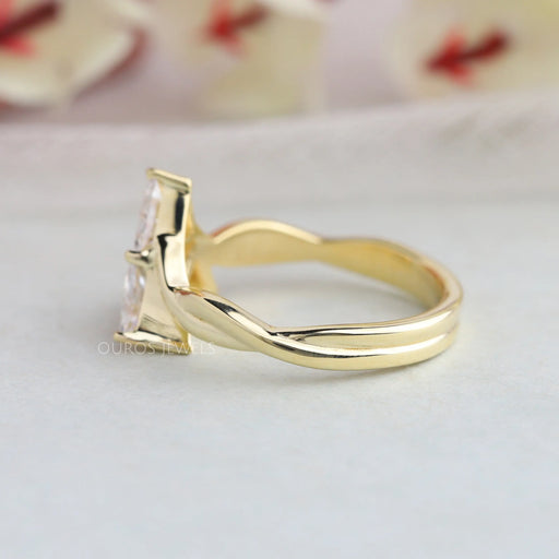 side view of three stone trillion cut diamond engagement ring in yellow gold band