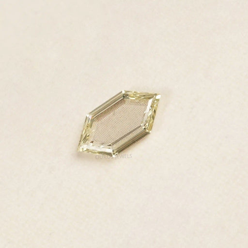 side view of fancy yellow hexagon long portrait cut diamond man made