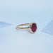 side view of oval cut ruby lab gemstone bezel set solitaire ring