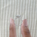 close up with side view of 3 carat oval cut diamond hidden halo engagement ring